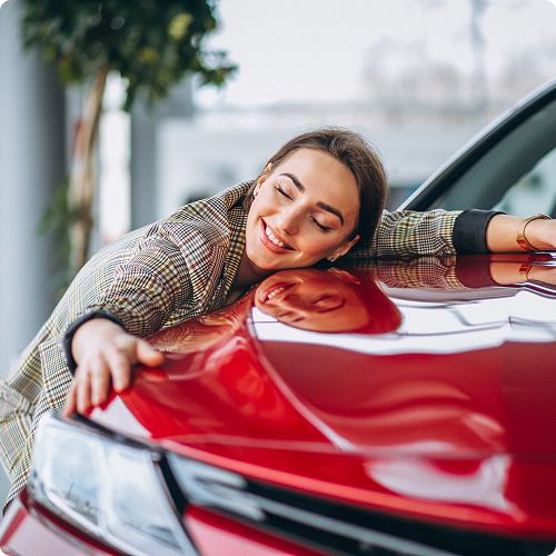 Happy customer hugging red car